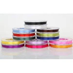 Flat elastic crystal string set with 13 vibrant colors on transparent plastic spools