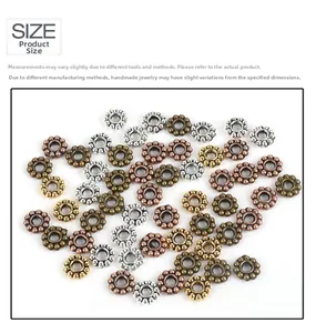 Macro detail of vintage petal-shaped metal spacer beads in four assorted finishes