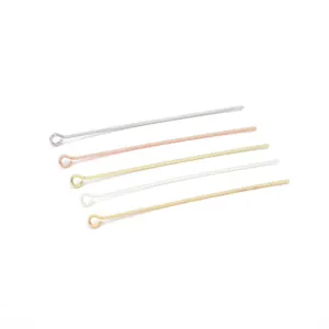 Macro view of assorted gold and silver eye pins for DIY jewelry making and beading