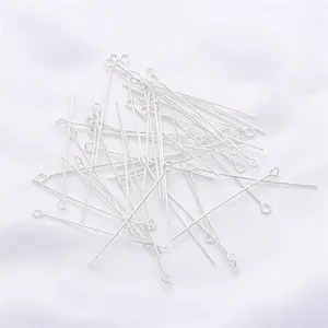 Macro view of bright silver eye pins for jewelry making and DIY beaded earrings
