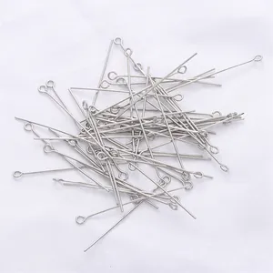 Close-up of bulk silver-plated 9-shape eye pins for DIY handmade jewelry and beaded crafts