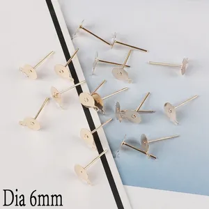 Macro detail of 6mm gold-plated earring studs with loops for DIY jewelry making