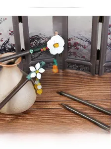 Detailed view of classical wooden hair sticks with floral accents and colorful bead tassels