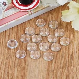 Close-up of clear faceted glass cabochons for DIY jewelry making on wooden background