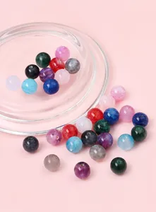 Detail of colorful glitter resin beads with pre-drilled holes for DIY jewelry making