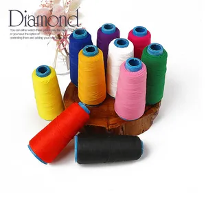 Macro shot of 10 assorted vibrant elastic sewing thread spools on a wooden base decor