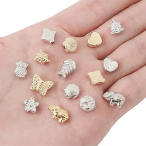 Assorted gold and silver animal and flower shaped beads for DIY jewelry making