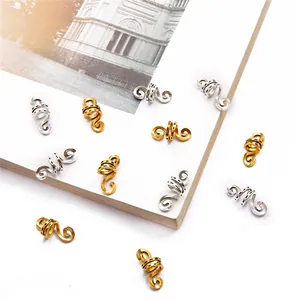 Macro detail of gold and silver spiral metal hair rings for dreadlocks and DIY jewelry