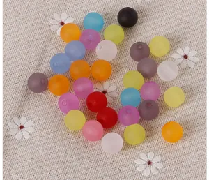 Macro shot of colorful matte acrylic beads with holes for DIY jewelry making and crafting