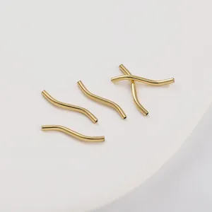 Detailed view of four 14K gold-filled S-shaped curved tube beads for DIY bracelet making