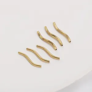 Macro shot of 6 pieces 14K gold filled S-curve wavy spacer beads for DIY jewelry