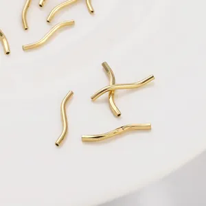 Macro shot of 14K gold plated S-curve tube beads for DIY jewelry making and bracelets
