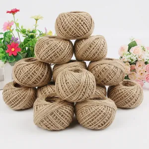 Natural jute twine rolls for DIY crafts and gift packaging shown with decorative flowers