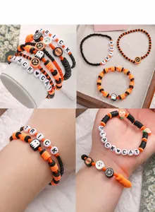 Detail showing Halloween themed handmade bracelets with ghost pumpkin and letter beads
