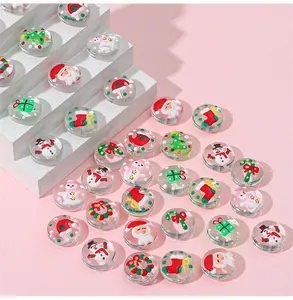 Detailed macro view of glass flat round beads featuring Christmas motifs for jewelry DIY