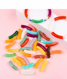 Detail of colorful acrylic curved tube beads with marble texture for DIY jewelry making
