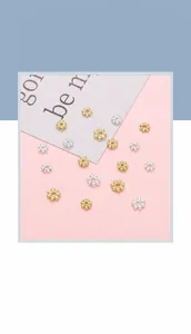 Detailed close-up of 14K gold plated snowflake spacer beads for DIY jewelry making
