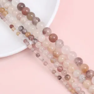 Macro shot of mixed natural stone beads showing smooth texture and various sizes