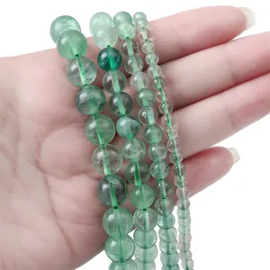 Detailed view of natural green translucent gemstone beads in four sizes for jewelry making
