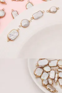 Macro detail of baroque pearls with gold plated edges and double loops for jewelry making