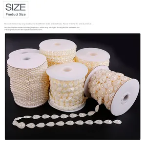 Detail of drop-shaped pearls and flower beads on a roll for DIY jewelry making