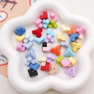 Close-up of colorful acrylic L-shaped building block beads in a flower tray for DIY crafts