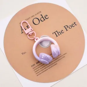 Pink and purple gradient headphone-shaped acrylic keychain with a matching D-ring