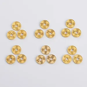 Close-up of golden Chinese copper coins with embossed ancient emperors' era names