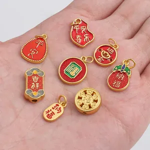 Detail view of 8 gold-plated Chinese lucky charms held in hand for size comparison