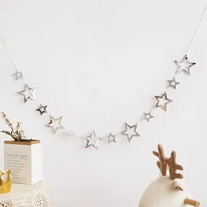 Close-up of hollow silver mirror star garland bunting for festive party wall decoration