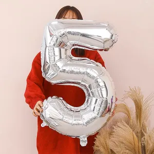 Large 32-inch silver number 5 foil balloon held by a model for birthday party decoration