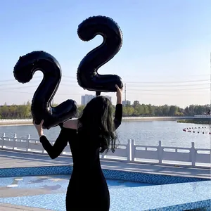 Black 32-inch number 22 foil balloons for birthday party decor with outdoor lake backdrop