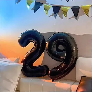 Black 32-inch number 29 foil balloons on a sofa for birthday party scene decoration