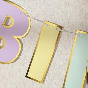 Pastel Happy Birthday banner with gold foil edges and white ribbon for party decoration