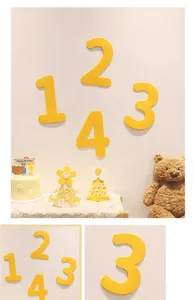 Detail of yellow felt numbers 1 to 4 for children's birthday party wall decoration