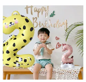 Detail of yellow leopard print and pink giraffe number 2 balloons for toddler birthday
