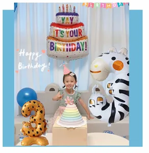 Close-up of animal print number 3 foil balloons and birthday cake decoration for party