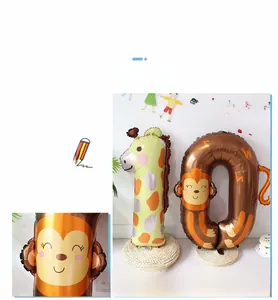 Detail of giraffe and monkey animal foil balloons with number zero for birthday party decor