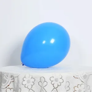 Close-up of a vibrant blue 10-inch latex balloon on a white lace tablecloth for parties