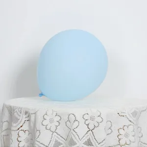 Close-up of a matte light blue latex balloon with detailed knot on elegant lace background