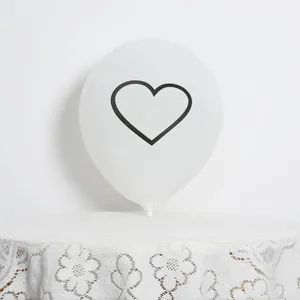 Close-up of a white latex balloon featuring a minimalist black heart outline design
