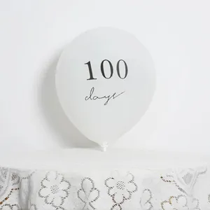 Detail of a white 100 days printed latex balloon for 100th day baby party decoration