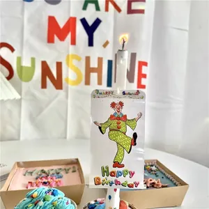 Creative clown banner birthday candle for cake decoration with a festive party setup