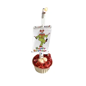 Happy Birthday clown banner cake topper with mini lights and a white flag on a cupcake