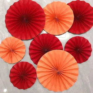 Red and orange paper fan decorations in various sizes for wedding and party events