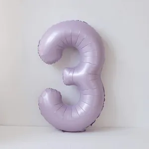 Macro shot of 40-inch cream purple number 3 foil balloon for birthday party decor