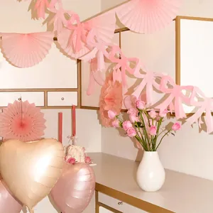 Pink butterfly paper banner and heart foil balloons for princess party atmosphere