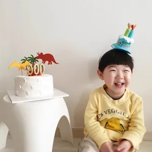 Kids birthday party headband and cake topper set with colorful dinosaur decorations
