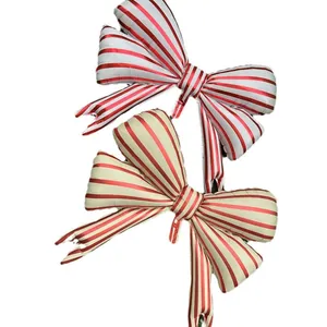 Bow tie foil balloons with festive red and white stripes for party decorations