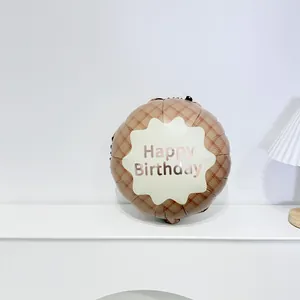 Close-up of brown plaid foil balloon with pink gold Happy Birthday lettering for parties